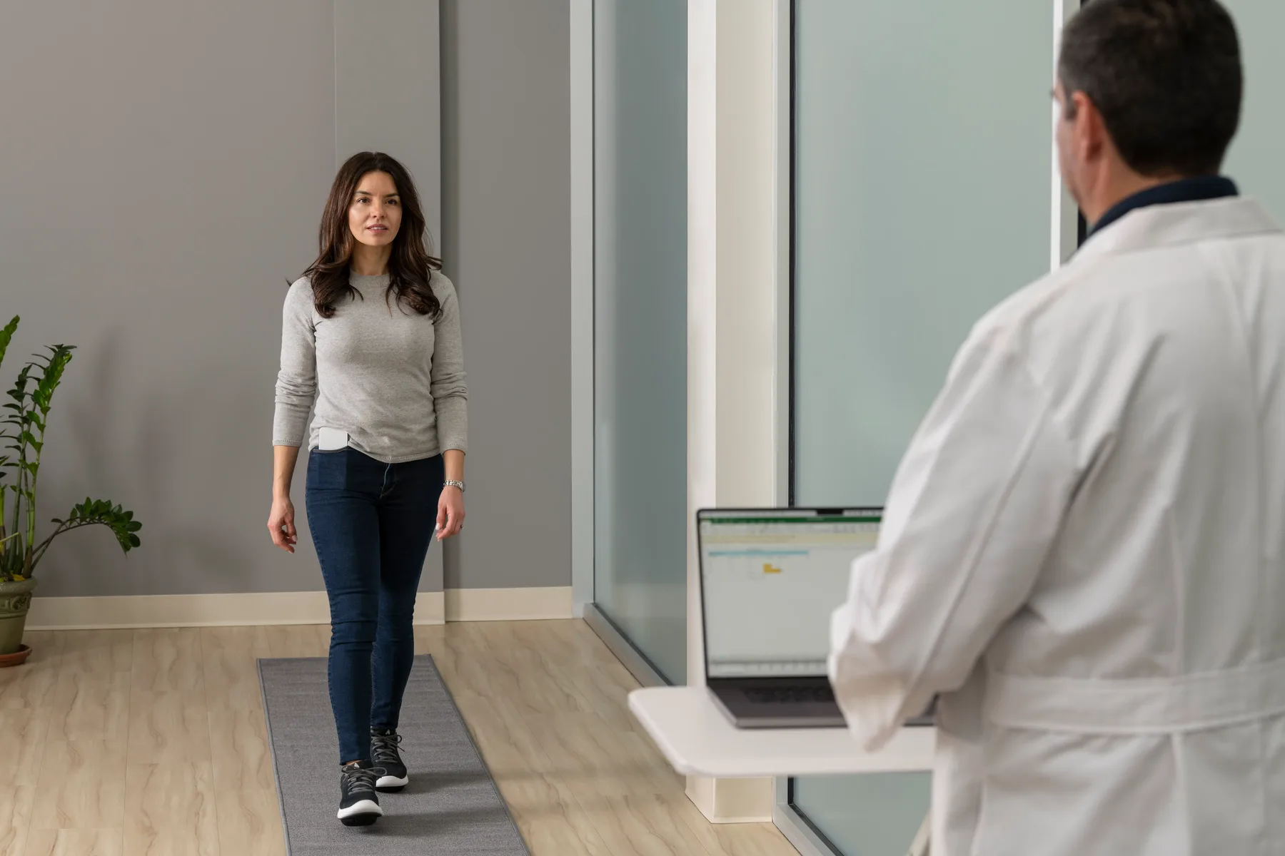 A clinician observing a patient during a gait assessment